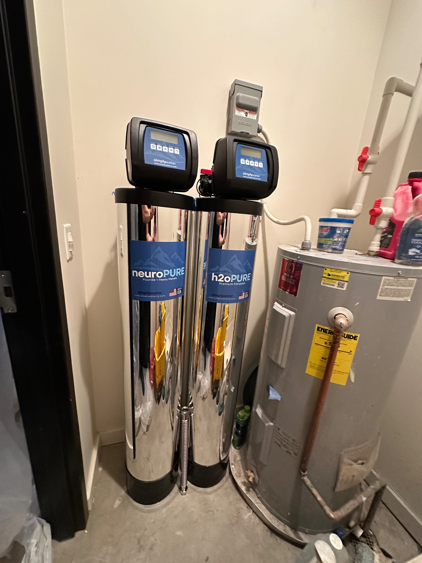 Compact two-tank Simply Water installation in a residential utility closet
